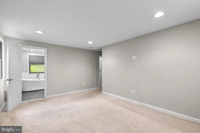 an empty room with a window and wooden floor