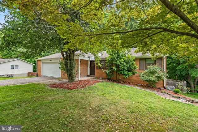 a front view of house with yard and trees
