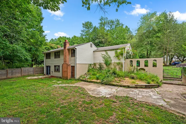 a view of a house with a yard and potted plants