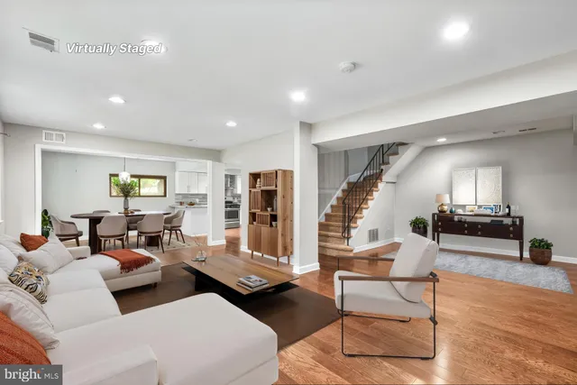 a living room with furniture and wooden floor