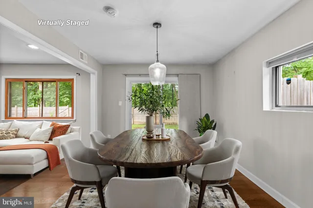 a dining room with furniture a window and a chandelier