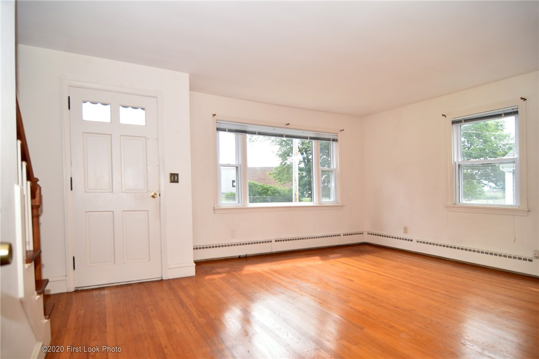 89 Bliss Mine Road Newport, RI 02840 - Photo 3 of 34 Living/ family room with picture frame hard wood floors