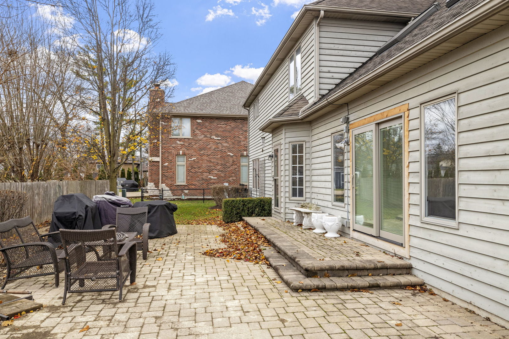 1203 North Burning Bush Lane Mount Prospect, IL 60056 - Photo 24 of 29 a view of a patio with couches table and chairs and potted plants