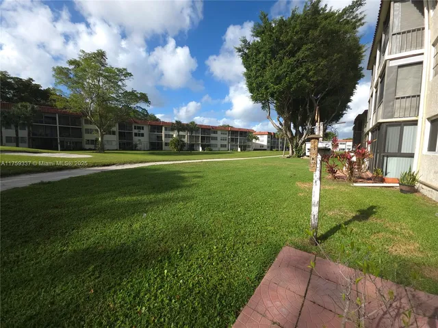 a view of a park with large trees