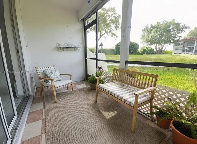 a view of a chair and tables in the balcony