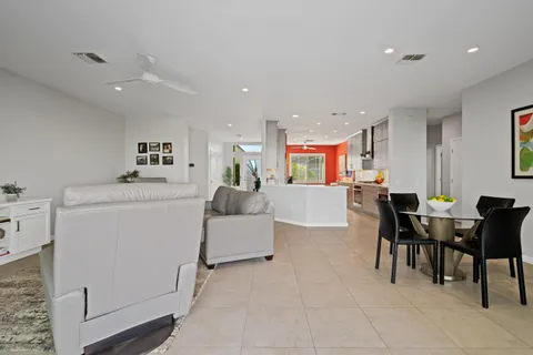 a living room with furniture a dining table and kitchen view