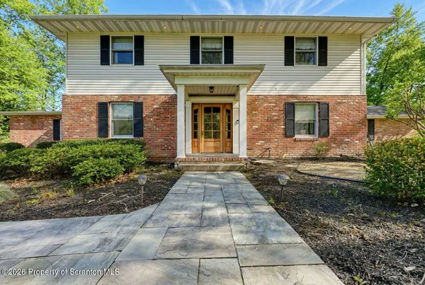 a kitchen with stainless steel appliances granite countertop a stove a sink and a granite island