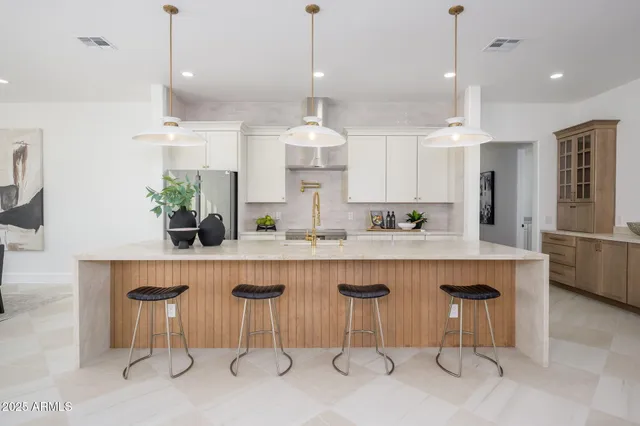 a kitchen with a table chairs sink and cabinets