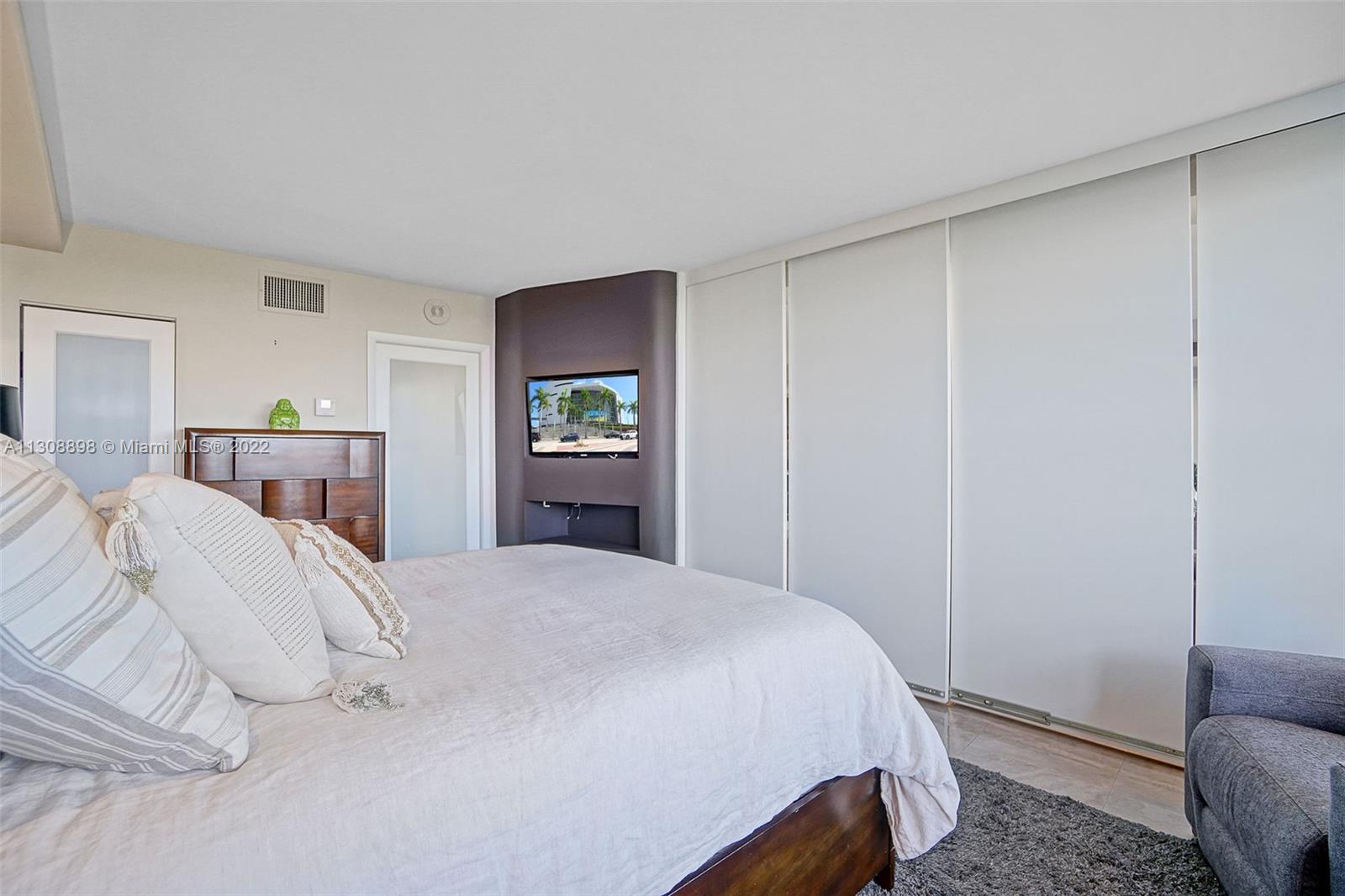 780 Northeast 69th Street, Unit 804 Miami, FL 33138 - Photo 14 of 22 a bedroom with a bed and a couch