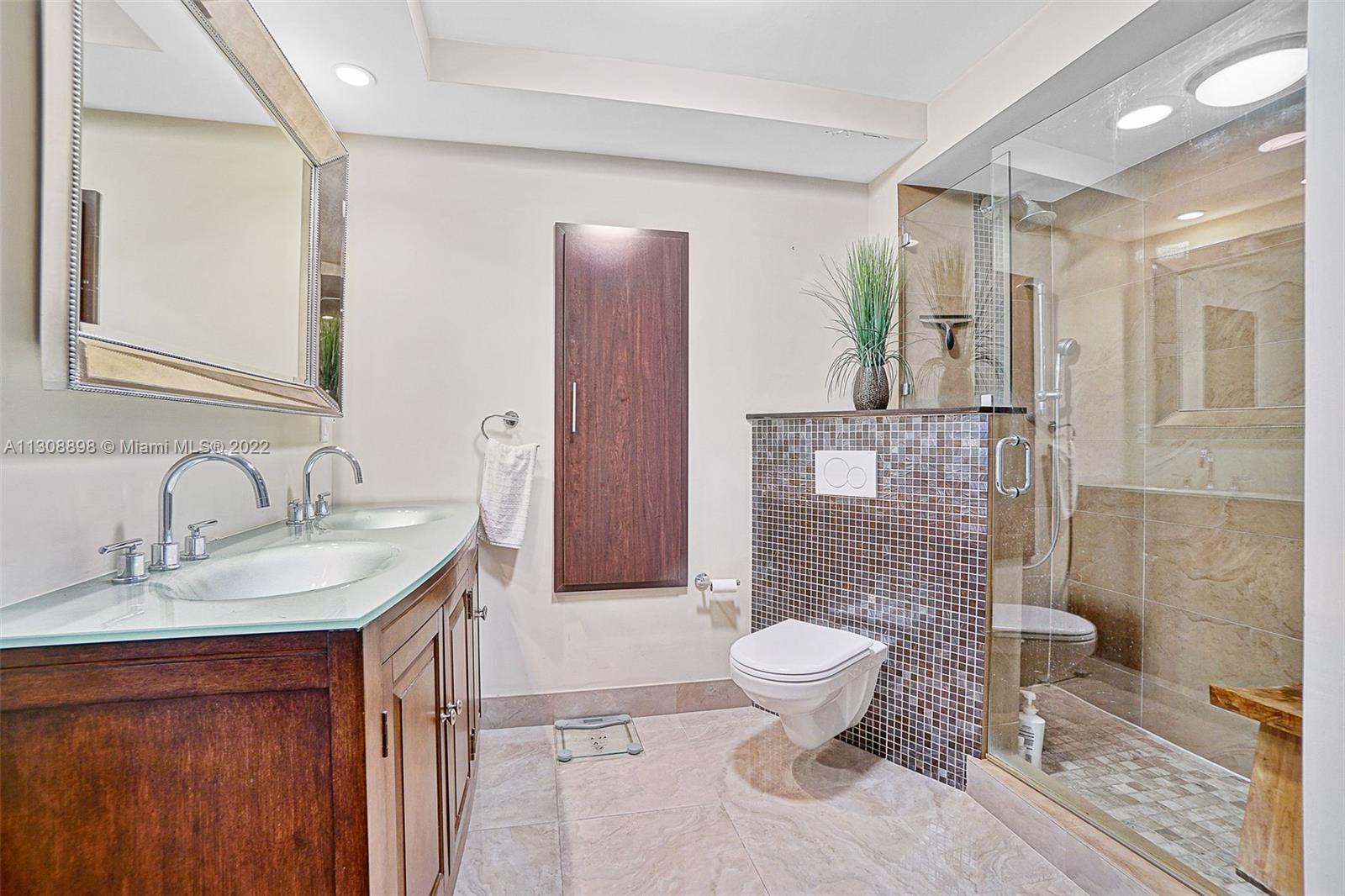 780 Northeast 69th Street, Unit 804 Miami, FL 33138 - Photo 16 of 22 a bathroom with a sink toilet and shower