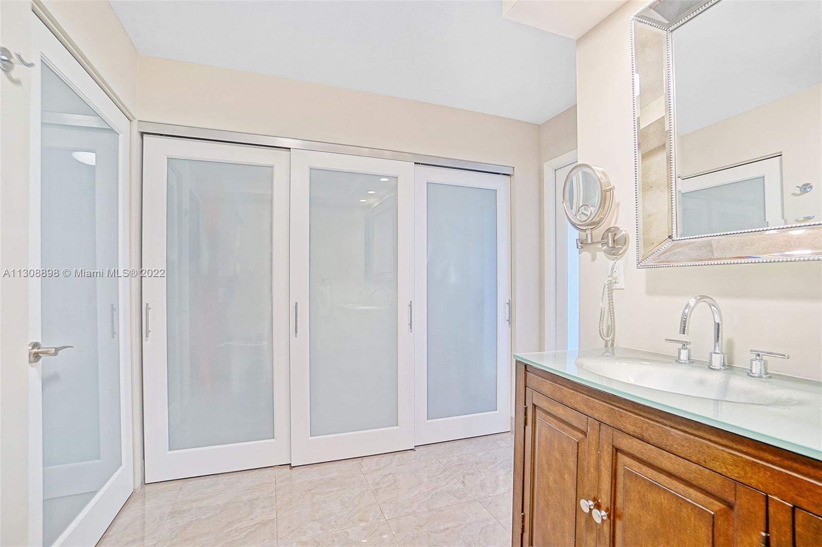 780 Northeast 69th Street, Unit 804 Miami, FL 33138 - Photo 17 of 22 a bathroom with a sink and a mirror