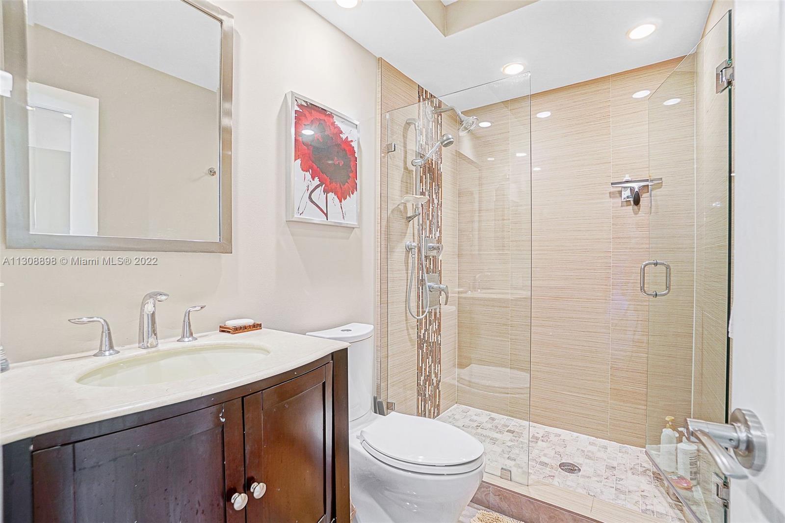 780 Northeast 69th Street, Unit 804 Miami, FL 33138 - Photo 19 of 22 a bathroom with a sink toilet double vanity and shower