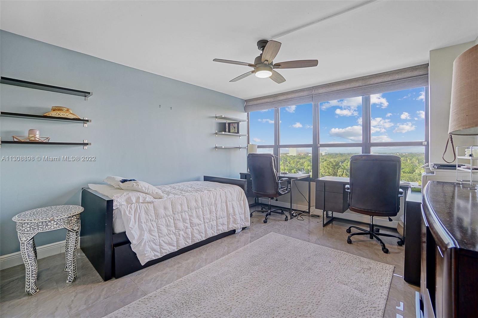 780 Northeast 69th Street, Unit 804 Miami, FL 33138 - Photo 20 of 22 a bedroom with a bed a desk and chair