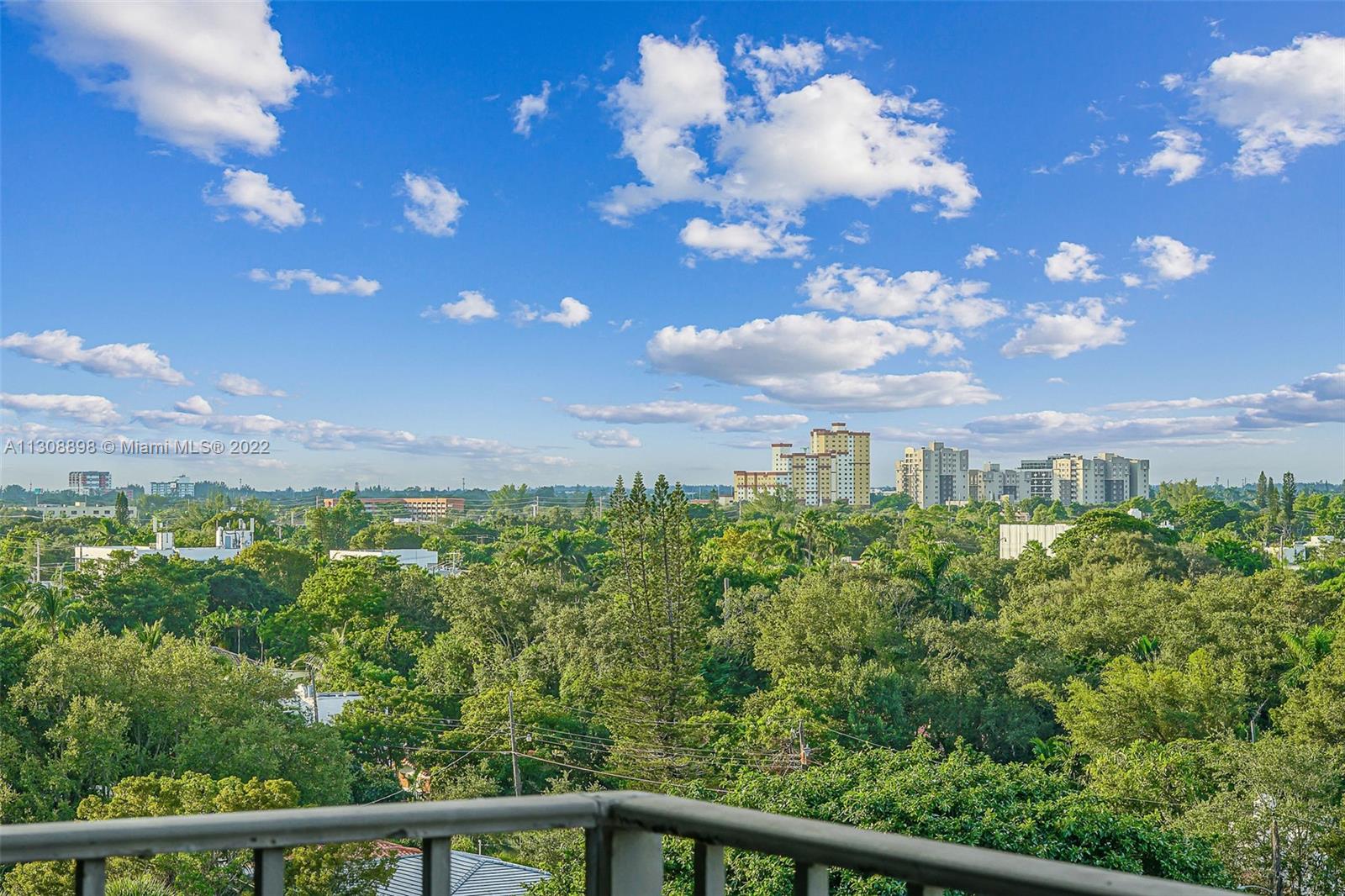 780 Northeast 69th Street, Unit 804 Miami, FL 33138 - Photo 3 of 22 a view of a city with lush green forest