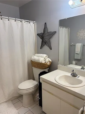 a white toilet sitting next to a bathroom sink