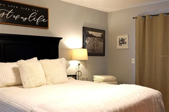 a bedroom with a bed and a night stand