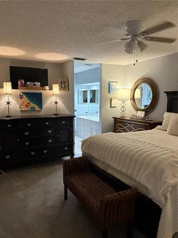 a bedroom with a bed a mirror and a table