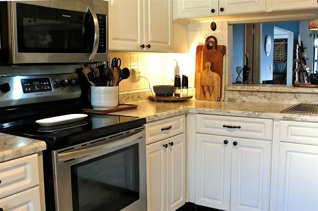 a kitchen with a stove and a microwave