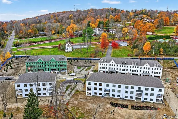 an aerial view of residential building with parking