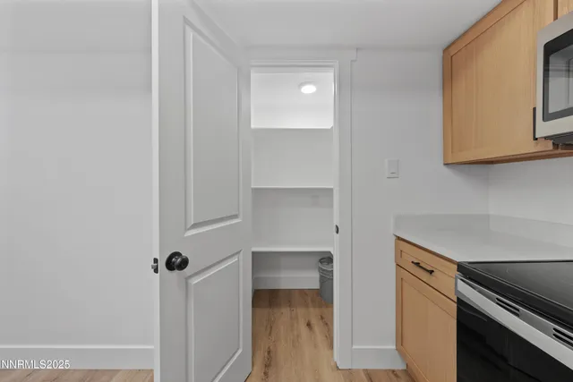 a living room with furniture a flat screen tv and a floor to ceiling window