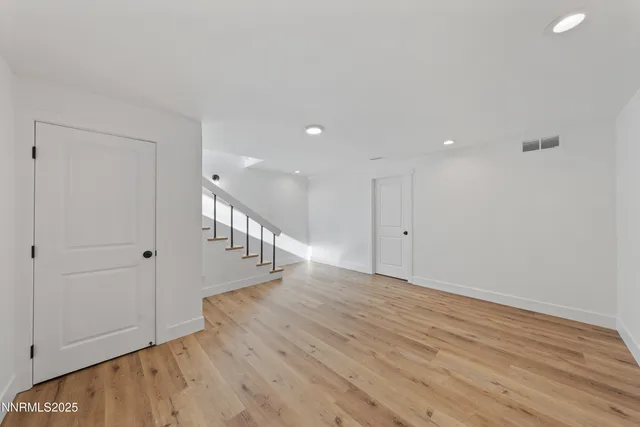 a view of a big room with closet and windows