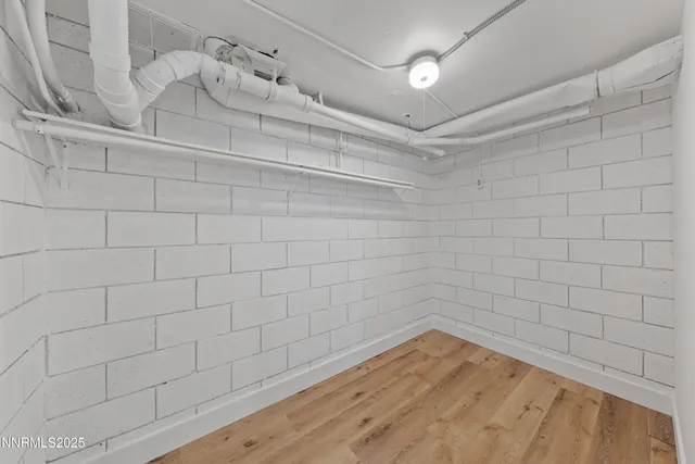 a view of a room with wooden floor and a floor to ceiling window