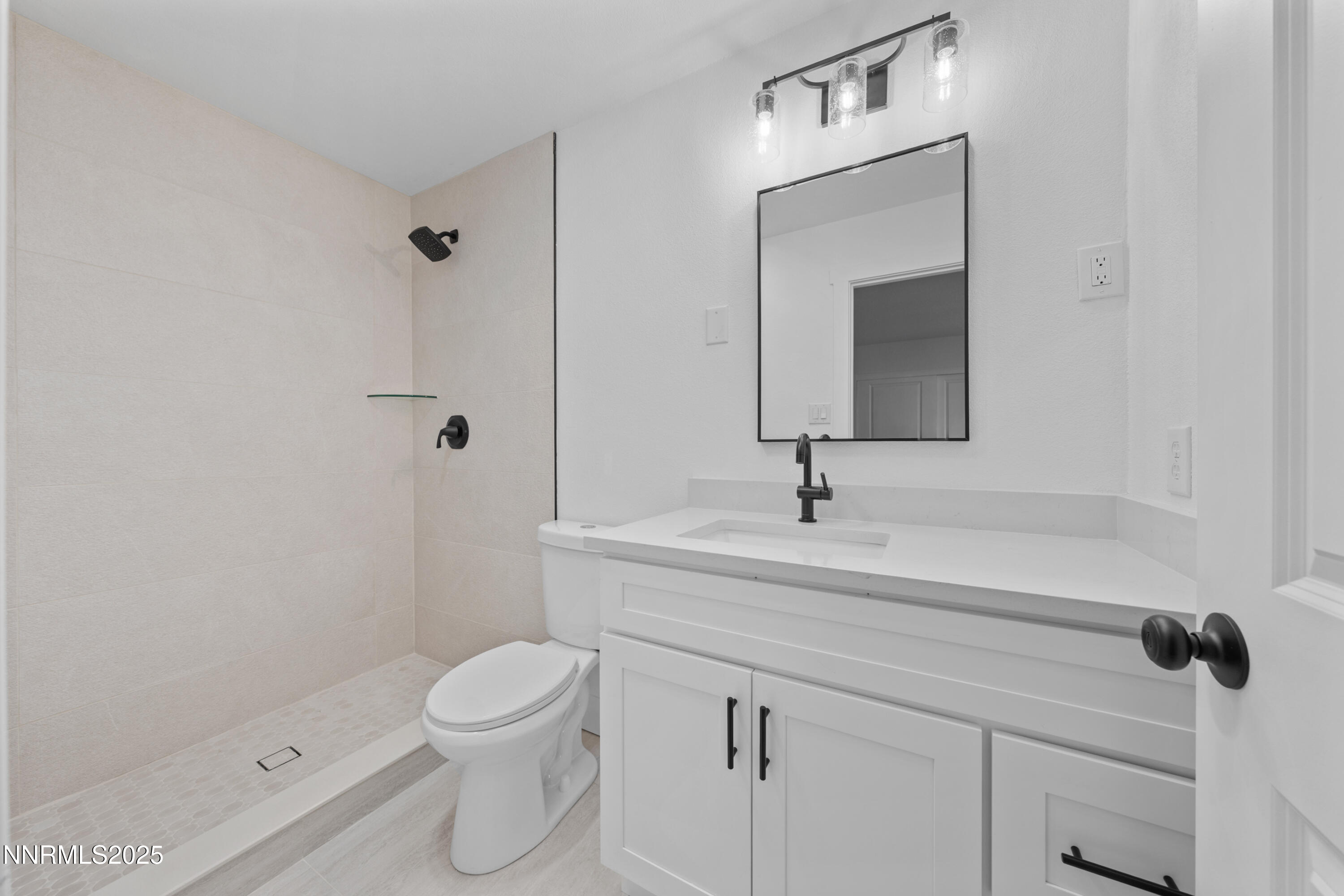 1340 Jones Street Reno, NV 89503 - Photo 49 of 58 a bathroom with a sink a toilet and a mirror