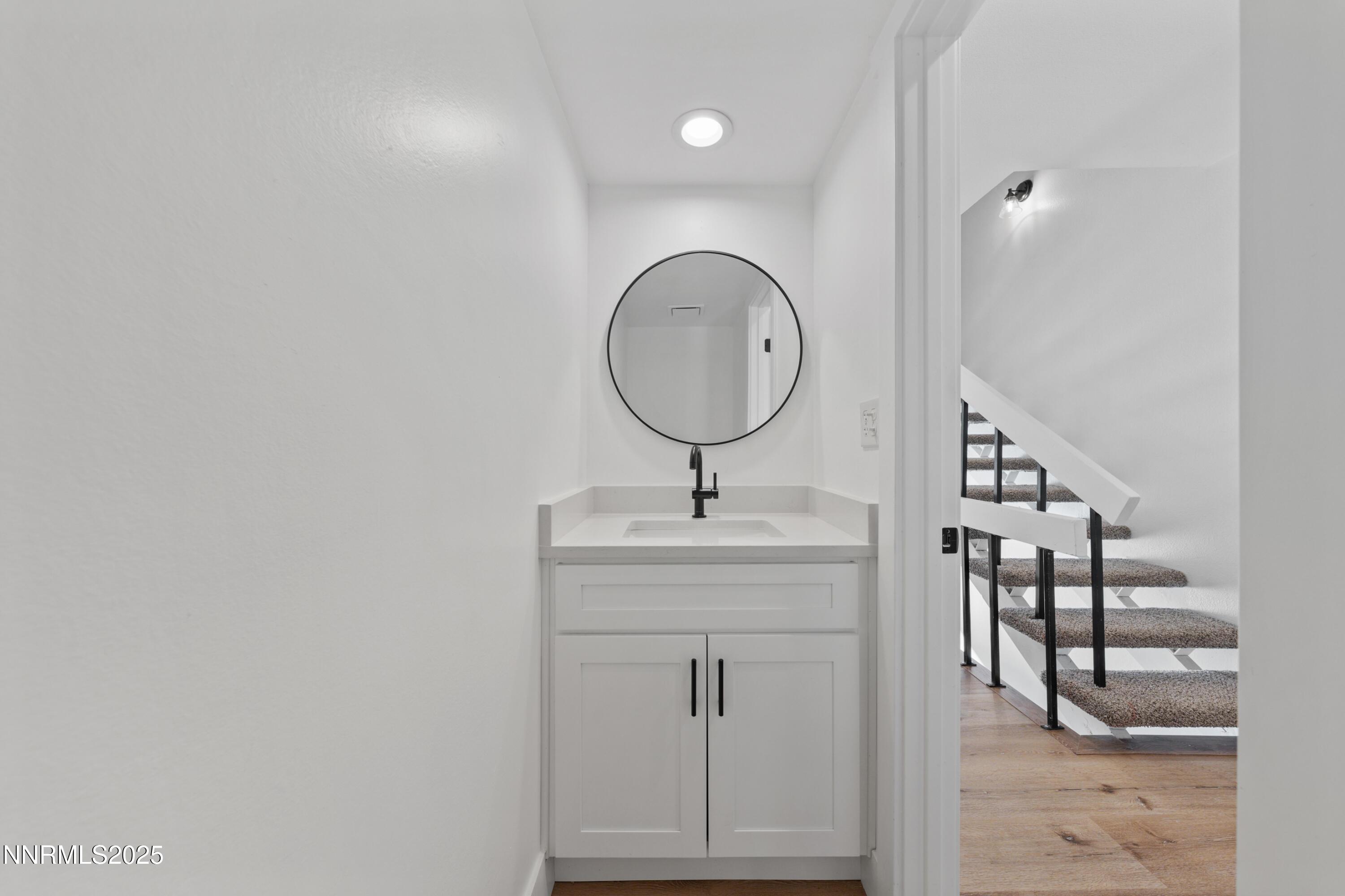 1340 Jones Street Reno, NV 89503 - Photo 50 of 58 a bathroom with a sink a light fixture and a mirror