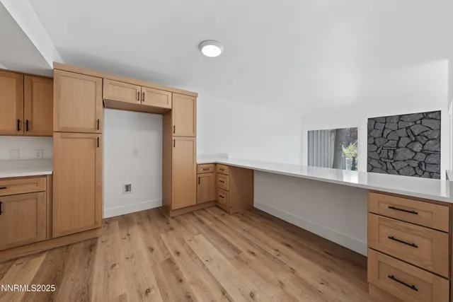 a kitchen with white cabinets and sink