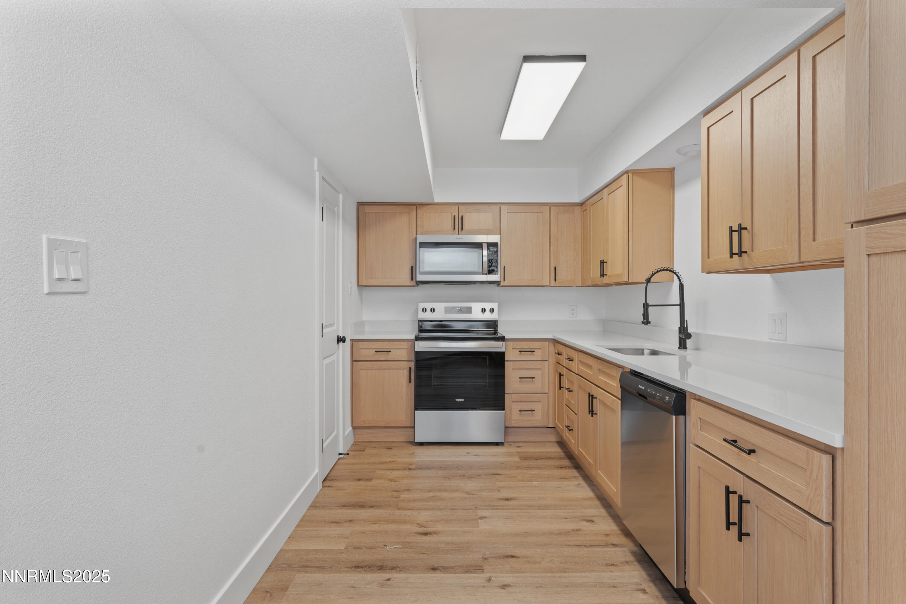 1340 Jones Street Reno, NV 89503 - Photo 10 of 58 a kitchen with granite countertop a stove top oven sink and cabinets