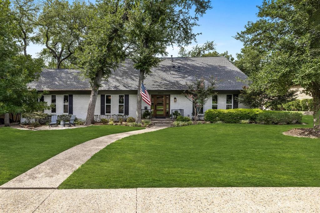 a black and white house with a garden