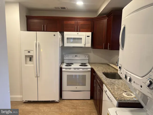 a kitchen with a sink a stove and a refrigerator
