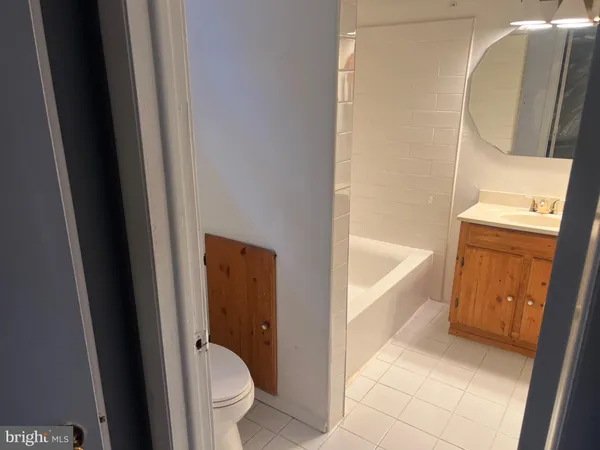a bathroom with a tub and toilet