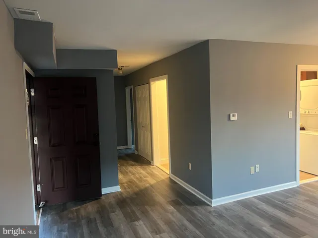 a view of hallway with wooden floor