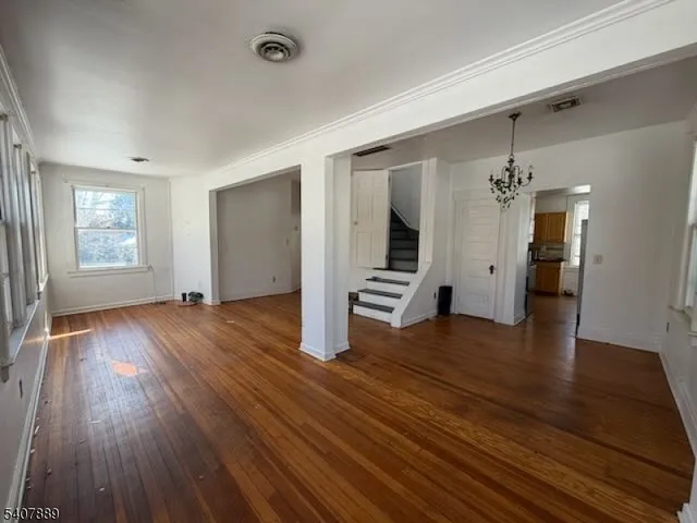 a view of staircase with wooden floor and a window