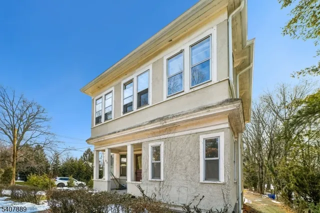 a front view of a building with a garden