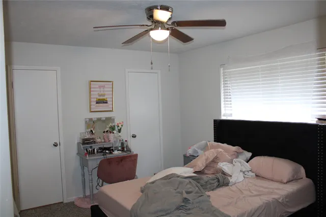 a bathroom with a granite countertop sink toilet and mirror