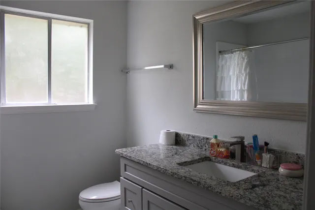 a view of backyard with table and chairs and a large tree