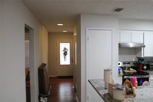 a kitchen that has a lot of cabinets a stove and a refrigerator