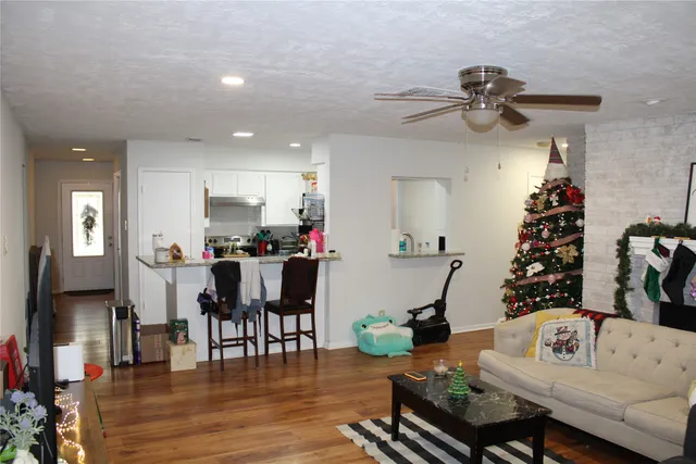 a living room with furniture and a dining room