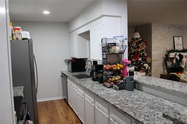 a kitchen with a refrigerator and a sink