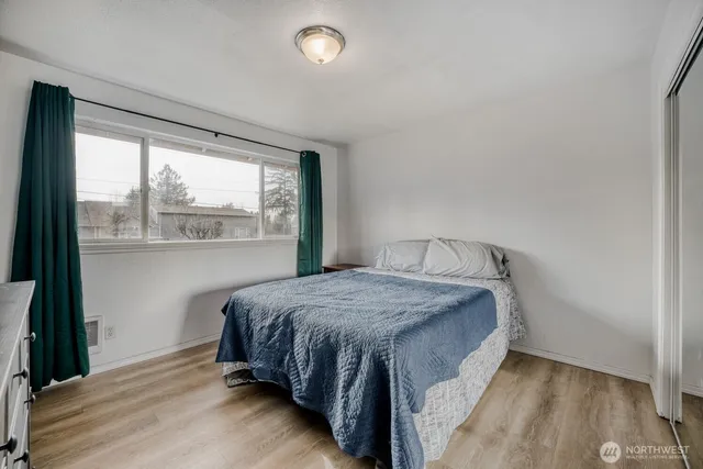 a bedroom with a bed and window