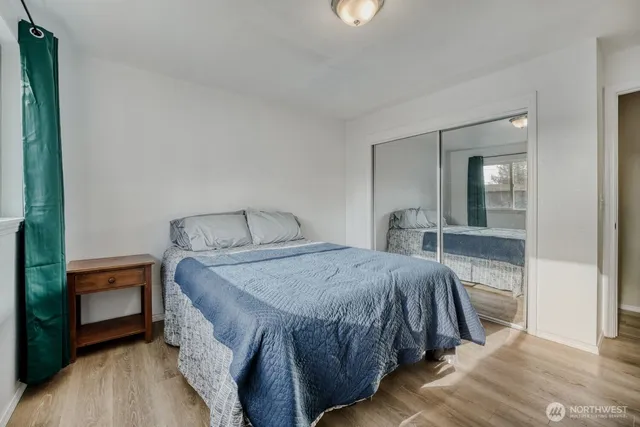 a bedroom with a bed and a mirror