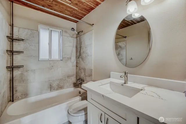 a bathroom with a sink a toilet and a mirror