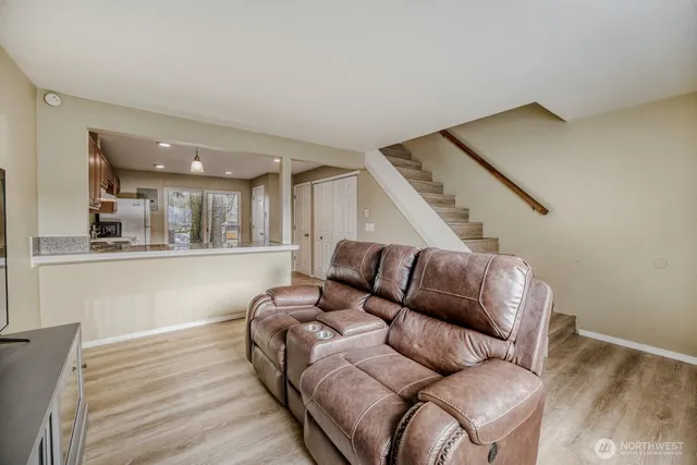 a living room with furniture and stairs