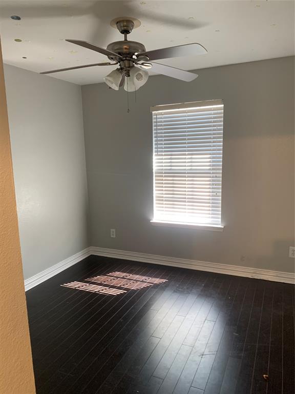 12226 Peak Circle Frisco, TX 75035 - Photo 14 of 27 a view of an empty room with wooden floor and a window