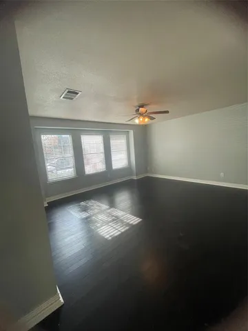 a view of wooden floor and windows in a room