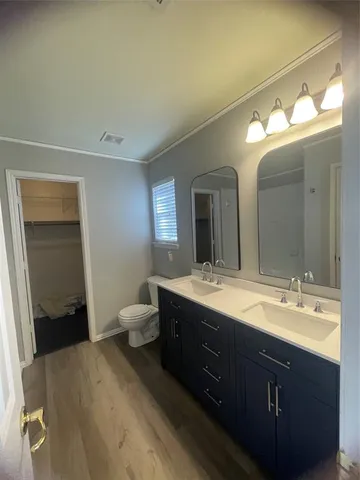 a bathroom with a double vanity sink and a mirror
