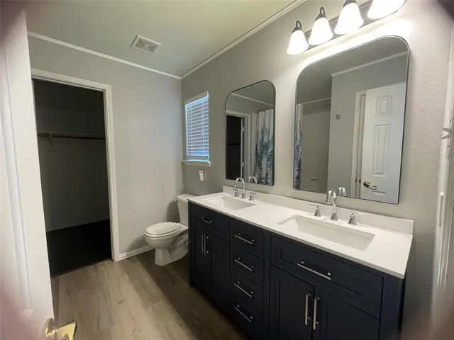 a bathroom with a double vanity sink and a mirror