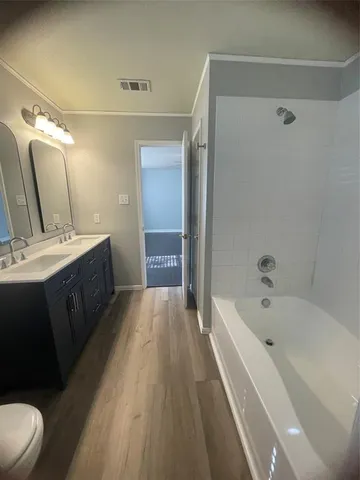 a bathroom with a tub sink and mirror
